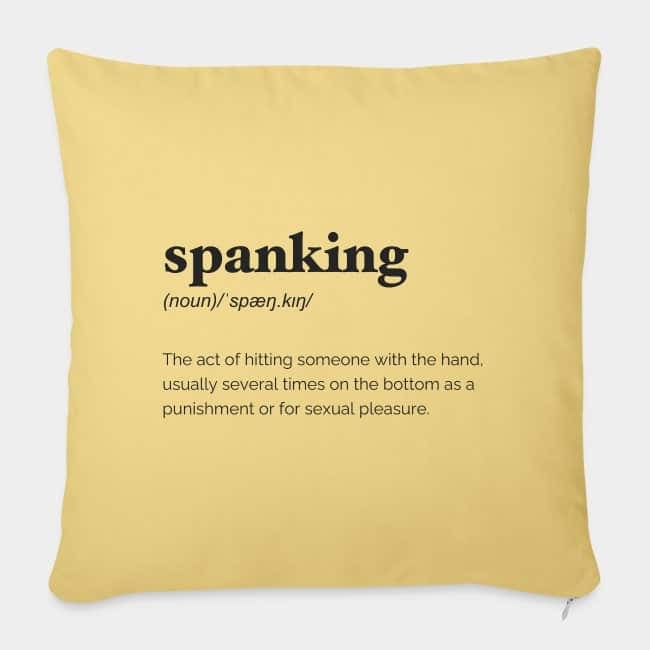 Cojín amarillo con la definición de diccionario de «spanking» estampada