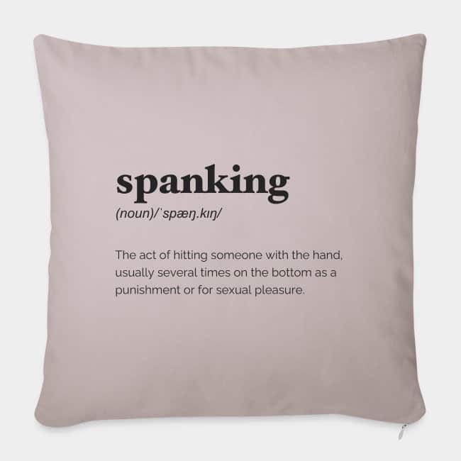 Cojín rosa empolvado con la definición de diccionario de «spanking» estampada