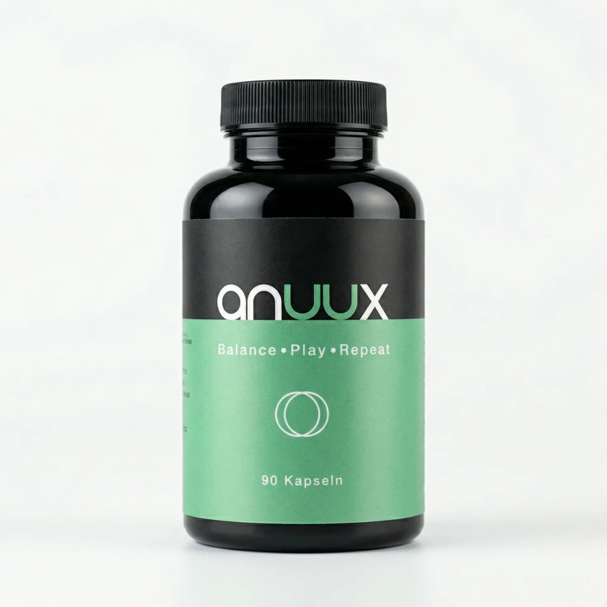 Bote negro «anuux — Balance · Play · Repeat» con etiqueta verde que indica 90 cápsulas, sobre fondo claro